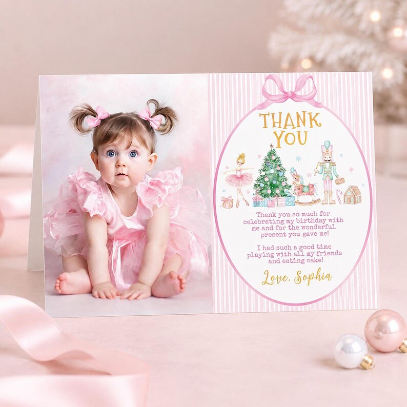 May include: A rectangular thank you card featuring a photograph of a toddler in a pink dress with bows on the left and a pink striped panel on the right. The right side displays a gold text header, a nutcracker illustration, and the name Sophia.