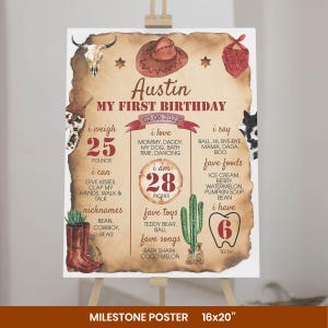 May include: A milestone poster with a western theme featuring a cow skull, cowboy hat, and bandana. The text reads Austin, My First Birthday, 02.06.2022, 25 pounds, 28 inches, and 6 teeth, alongside lists of favorite things, nicknames, and abilities.