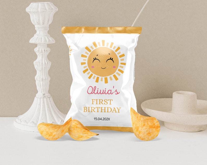 May include: A white bag of chips with a yellow sun design and the text "Olivia's First Birthday 15.04.202X".