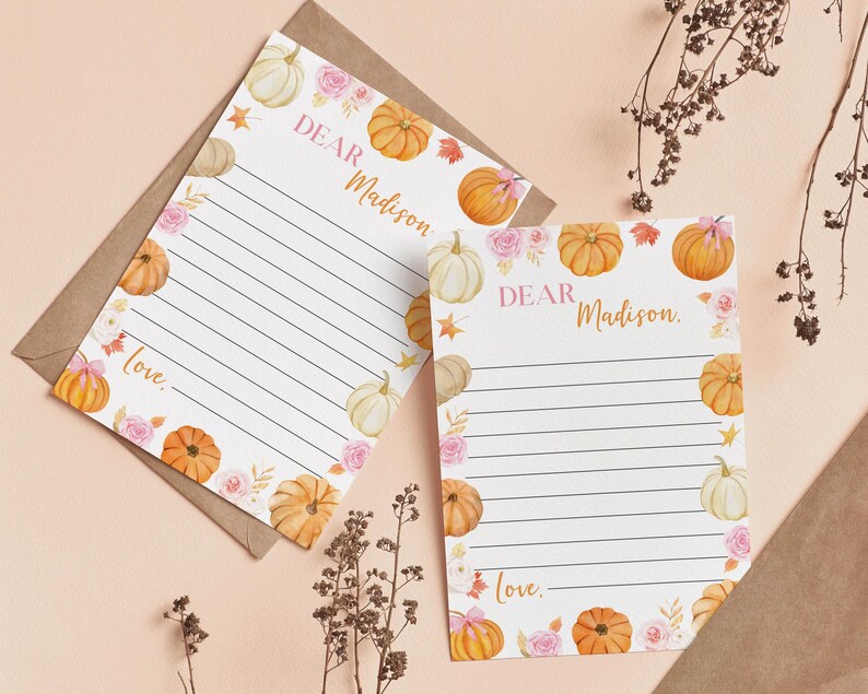 Puede incluir: Dos hojas de papel de carta blancas con l&iacute;neas negras horizontales, con ilustraciones en acuarela de calabazas naranjas y blancas, rosas rosadas y hojas de oto&ntilde;o. El texto "Dear Madison" y "love." est&aacute; impreso en una fuente dorada.
