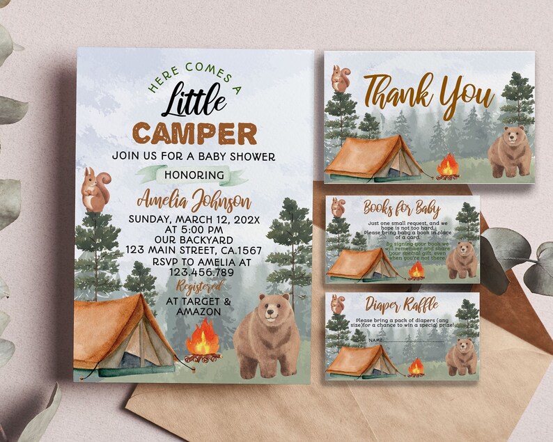 May include: A baby shower invitation with a woodland theme. The invitation features a brown bear, a squirrel, a campfire, and a tent. The text on the invitation reads "Here comes a little camper" and includes the baby's name, date, time, and location. The invitation also includes information about where to register for gifts.