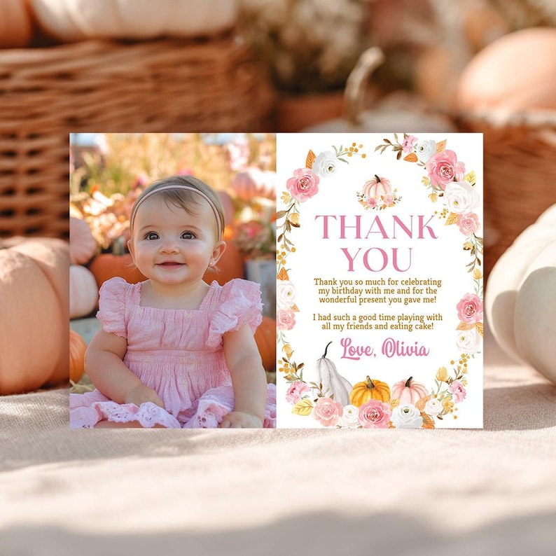 May include: A pink and white thank you card with a photo of a smiling baby girl in a pink dress. The card features floral and pumpkin designs and the text "THANK YOU". The card reads "Love, Olivia".