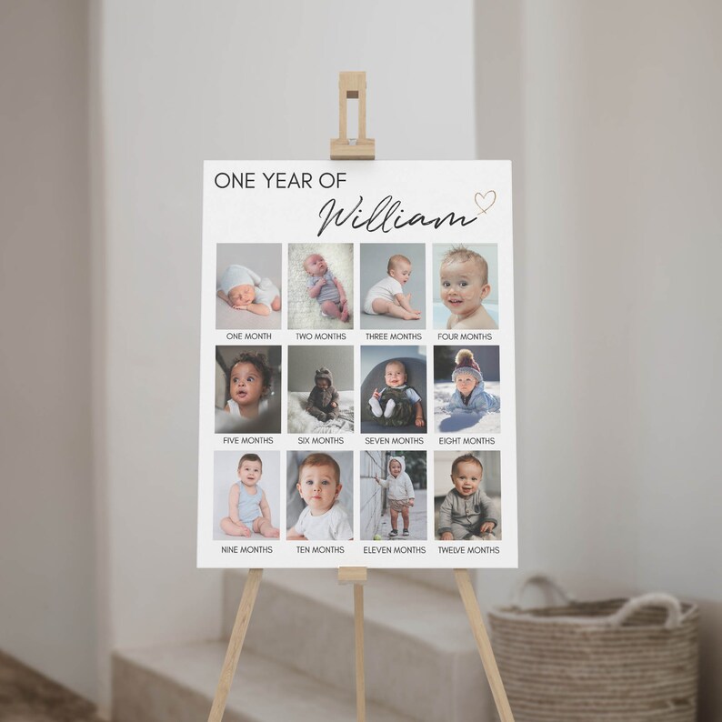 May include: A white rectangular milestone poster titled ONE YEAR OF William with a small heart icon. The poster features twelve individual photographs of a child arranged in a grid, each labelled with a month from one to twelve months below.