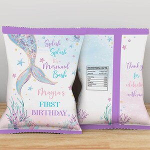 May include: Two custom chip bags featuring a mermaid tail illustration, pastel watercolor accents, and sea-themed graphics. Text includes Splish Splash It's a Mermaid Bash, Mayra's FIRST BIRTHDAY, and a nutrition facts label listing friendship and love.