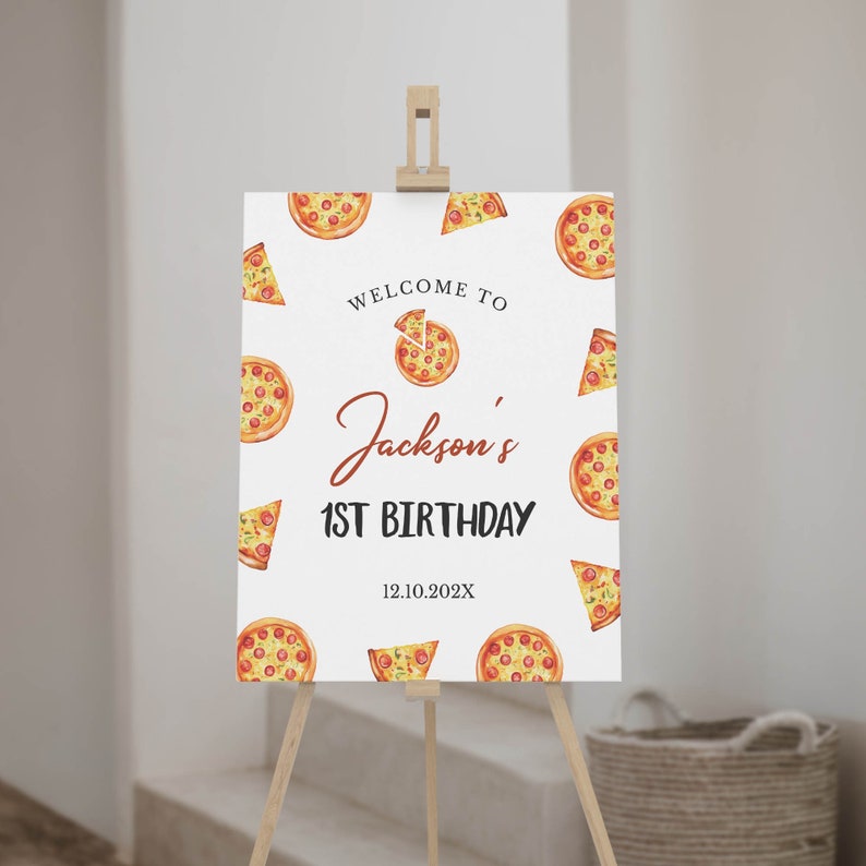 May include: Welcome to Jackson's 1st Birthday sign with a pizza theme. The white sign has a red and brown welcome to Jackson's 1st Birthday text with a pizza slice graphic. The background is covered with pizza slices in various positions.