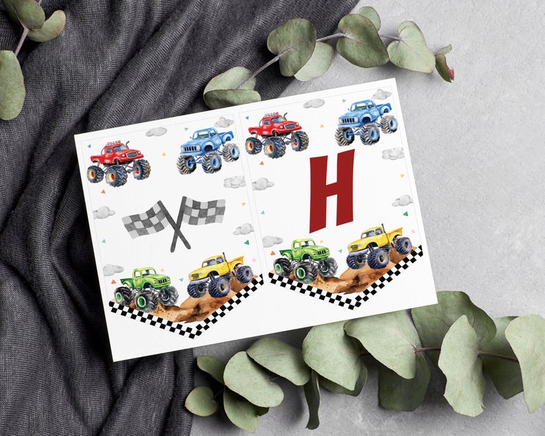 May include: Monster truck birthday banner with the letter H in red. The banner features a checkered flag and several monster trucks in various colors, including red, blue, green, and yellow.