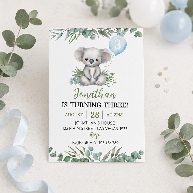 May include: A white birthday invitation card featuring a watercolor koala holding a light blue balloon with the number 3. The text reads: Jonathan IS TURNING THREE! AUGUST 28 AT 2PM JONATHAN'S HOUSE 123 MAIN STREET, LAS VEGAS. 1235 RSVP TO JESSICA AT 123.456.789.