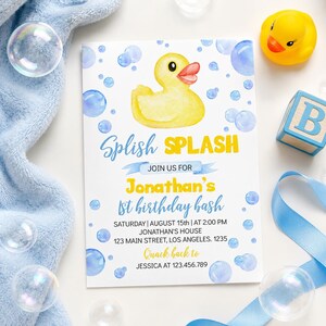 May include: A birthday invitation with a yellow rubber duck illustration and blue bubble accents. The text reads "Splish Splash" and invites guests to Jonathan's 1st birthday bash. Includes details like date, time, and location.