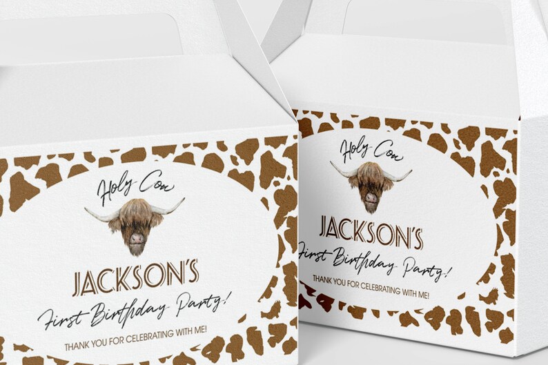 May include: Two white cardboard favor boxes featuring a brown cow print border. The center oval graphic displays a Highland cow illustration, the text "Holy Cow," "JACKSON'S First Birthday Party!," and "THANK YOU FOR CELEBRATING WITH ME!" in black.