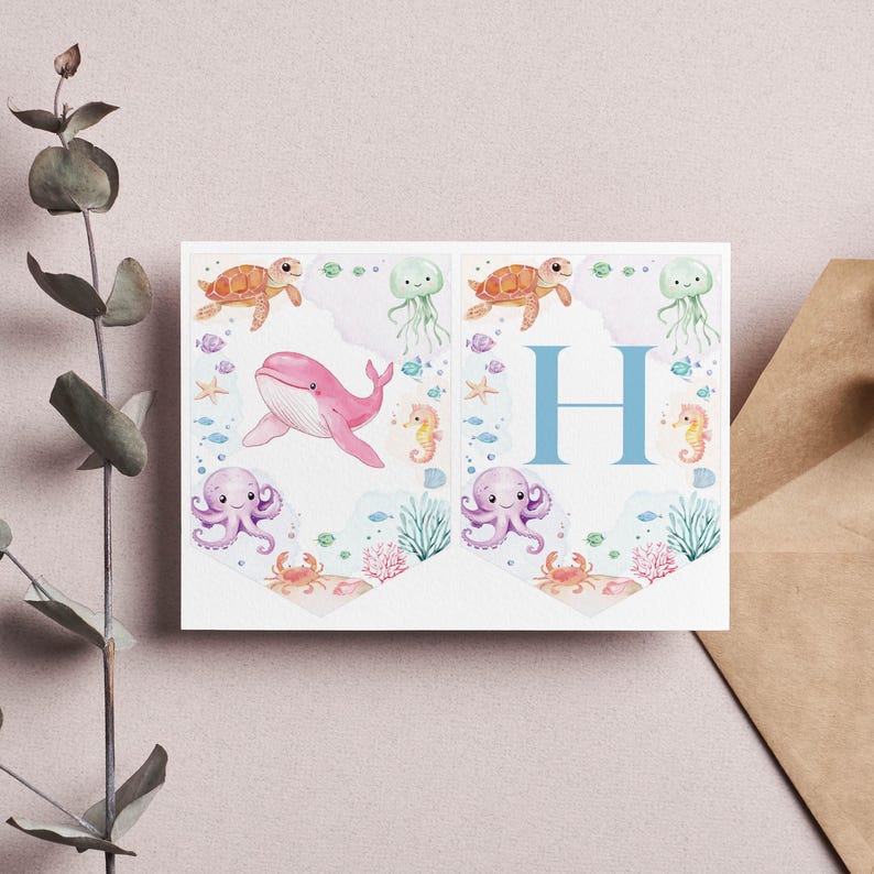 Peut inclure: Une banni&egrave;re bleu clair avec la lettre "H" au centre. La banni&egrave;re est d&eacute;cor&eacute;e de cr&eacute;atures marines, dont une baleine rose, une pieuvre violette, des tortues de mer orange et des hippocampes jaunes. L'arri&egrave;re-plan est une aquarelle bleu clair.
