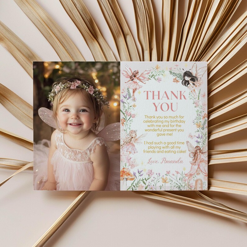 May include: A pink thank you card with a photo of a young girl wearing a fairy costume and a flower crown. The card has a floral border and the text "Thank You" in pink. The text reads "Thank you so much for celebrating my birthday with me and for the wonderful present you gave me! I had such a good time playing with all my friends and eating cake! Love, Amanda."