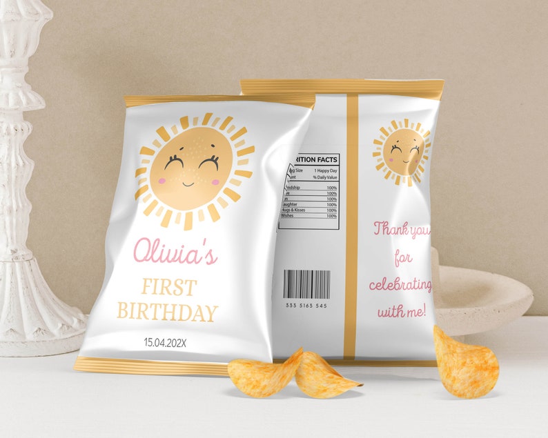 May include: A white chip bag with a gold border and a smiling sun graphic. The bag is personalized with the text "Olivia's First Birthday 15.04.202X".