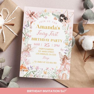 May include: A pink birthday invitation with a fairy theme. The invitation reads "Amanda's Fairy First Birthday Party" with the date March 25th at 2 PM. The design includes illustrations of fairies, flowers, and the text "Fairy's Garden, 123 Main Street, Los Angeles, CA 1235".