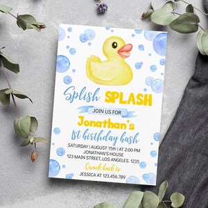May include: A white invitation card with a yellow rubber duck illustration and blue bubbles. The text reads "Splish SPLASH" and announces Jonathan's 1st birthday bash, including date, time, and location.
