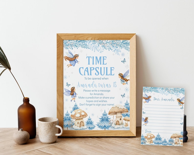 May include: A framed sign and a matching card featuring blue watercolor illustrations of fairies, pine trees, and mushroom houses. The sign reads: TIME CAPSULE To be opened when Amanda turns 18. Please write a message for Amanda.