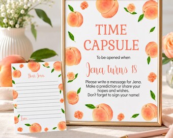 Puede incluir: Un letrero enmarcado y una tarjeta a juego con ilustraciones de melocotones y flores. El letrero dice: TIME CAPSULE To be opened when Jena turns 18. Please write a message for Jena. Make a prediction or share your hopes and wishes.