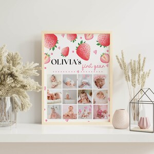 K&ouml;nnte beinhalten: Ein rechteckiger gerahmter Druck mit einem Erdbeermotiv und dem Text "OLIVIA'S first year" oben. Unter dem Text zeigt ein Raster aus zw&ouml;lf einzelnen Fotos ein Baby in verschiedenen Phasen seines ersten Lebensjahres.