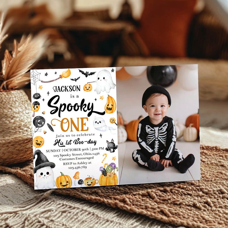 May include: A Halloween-themed photo card with the text "Jackson is a Spooky One" and a photo of a baby in a skeleton costume. The card includes Halloween illustrations like pumpkins, ghosts, and bats.