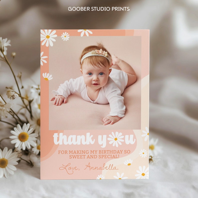 May include: A rectangular birthday thank you card featuring a photo of a baby wearing a white long-sleeve shirt and a floral headband. The card has a peach background with white daisy illustrations and the text thank you for making my birthday so sweet and special! Love, Annabella.