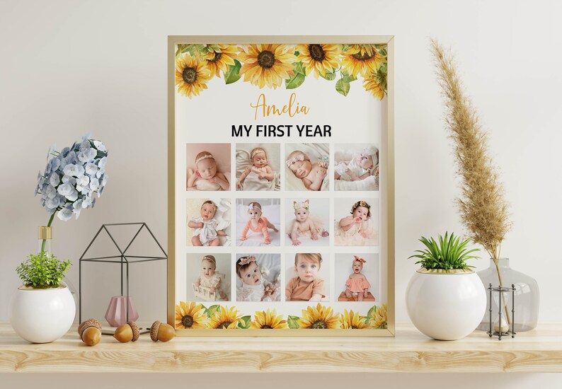 Może przedstawiać: Oprawiony kolaż zdjęć z dwunastoma zdjęciami dziecka, z napisem "Amelia MY FIRST YEAR". Rama jest ozdobiona akwarelowymi słonecznikami. Zdjęcia są ułożone w siatkę, prezentując pierwszy rok dziecka.