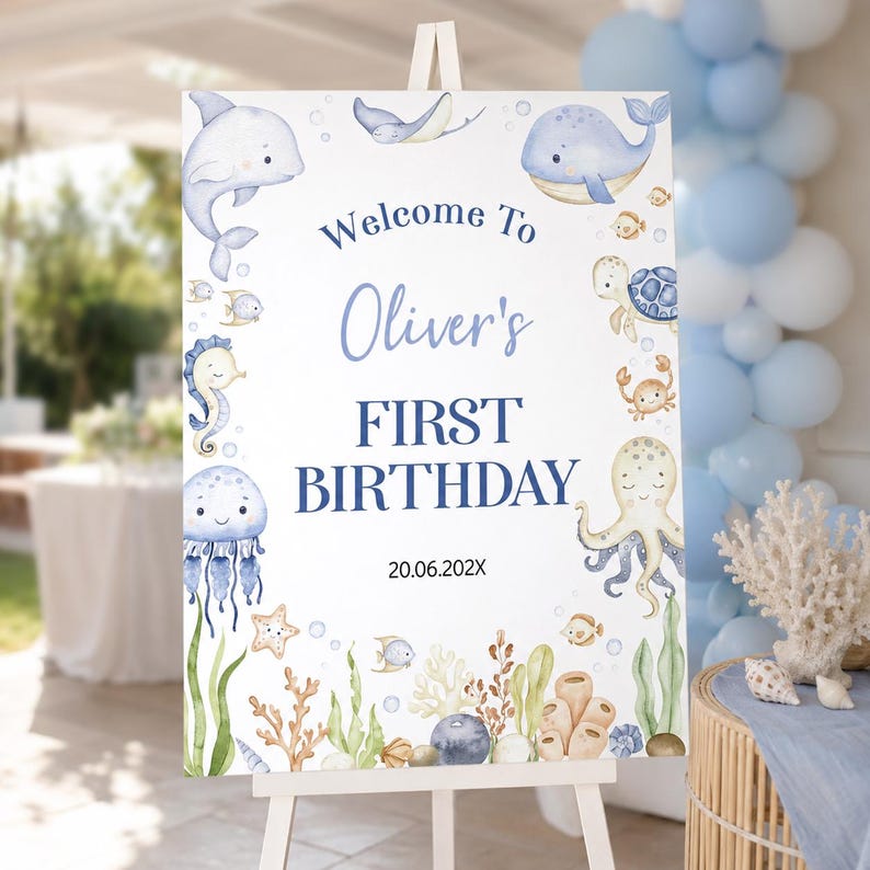 May include: A rectangular welcome sign for a first birthday featuring watercolour illustrations of a dolphin, whale, sea turtle, octopus, seahorse, and various fish. The text reads Welcome To Oliver's FIRST BIRTHDAY 20.06.202X on a white background.