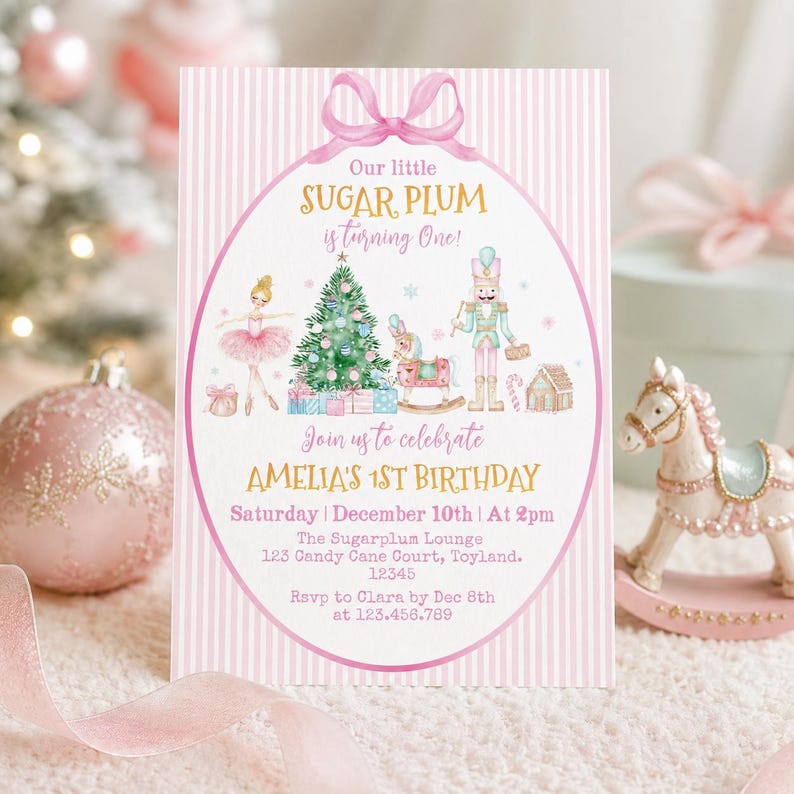 May include: A rectangular birthday invitation card with a pink and white striped background featuring a pink bow at the top. The text reads Our little SUGAR PLUM is turning One! Join us to celebrate AMELIA'S 1ST BIRTHDAY, Saturday December 10th at 2pm.