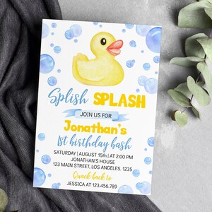 May include: A birthday party invitation featuring a yellow rubber duck and blue bubbles. The invitation reads "Splish Splash" and announces Jonathan's 1st birthday bash, including date, time, and location.