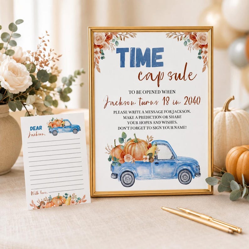 May include: A framed sign and a matching card for a time capsule event. The sign features a blue truck, pumpkins, and text reading TIME capsule TO BE OPENED WHEN Jackson turns 18 in 2040. The card has a blue truck and lines for writing messages.