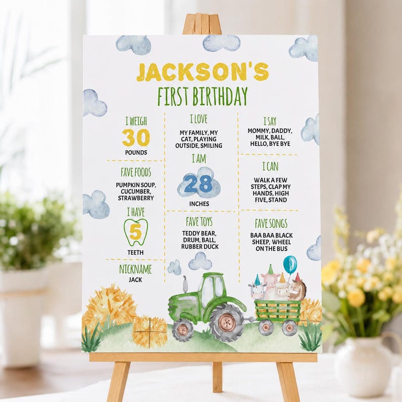 May include: A white birthday milestone sign featuring a green tractor pulling a trailer with animals, yellow text reading JACKSON'S FIRST BIRTHDAY, and sections detailing weight in pounds, height in inches, favorite foods, toys, songs, and words.