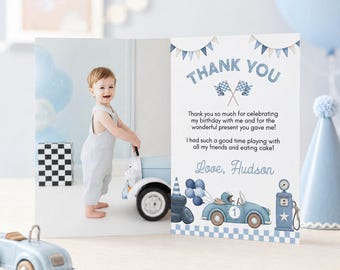 May include: A folded thank you card featuring a photo of a child standing next to a toy car on the left and a blue race car theme with text on the right. The text reads: THANK YOU, Thank you so much for celebrating my birthday with me and for the wonderful present you gave me! I had such a good time playing with all my friends and eating cake! Love, Hudson.