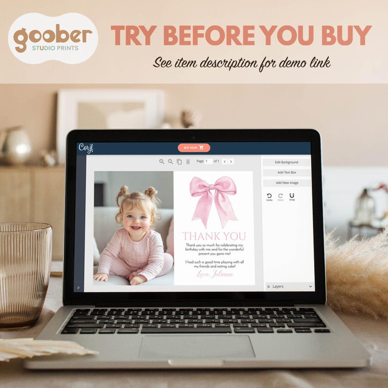 May include: A laptop displays a digital design for a baby's birthday thank you card. The card features a pink bow illustration and the words "THANK YOU." The screen also shows a photo of a smiling baby. The top of the screen has the text "TRY BEFORE YOU BUY."
