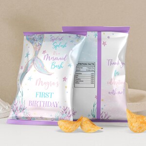 May include: Two custom chip bags with a mermaid theme, featuring a pastel color palette of blue, pink, and purple. The front displays a mermaid tail, coral, and text reading Splish Splash It's a Mermaid Bash Mayra's FIRST BIRTHDAY.