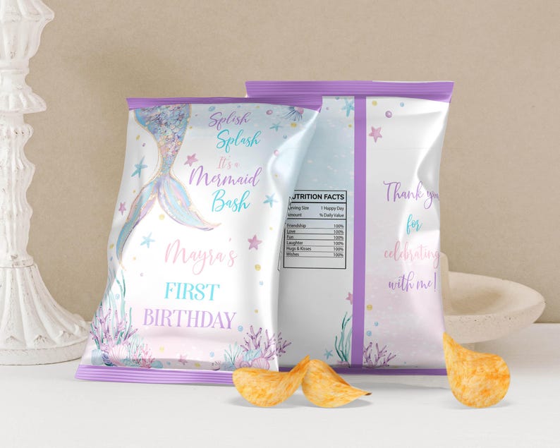 May include: Two custom chip bags with a mermaid theme, featuring a pastel color palette of blue, pink, and purple. The front displays a mermaid tail, coral, and text reading Splish Splash It's a Mermaid Bash Mayra's FIRST BIRTHDAY.