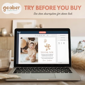 May include: A laptop screen displays a digital thank you card template featuring a photo of a baby in a bear-ear hood next to a graphic of a teddy bear holding a balloon with the number one. The text reads Thank You and Love, Jackson.