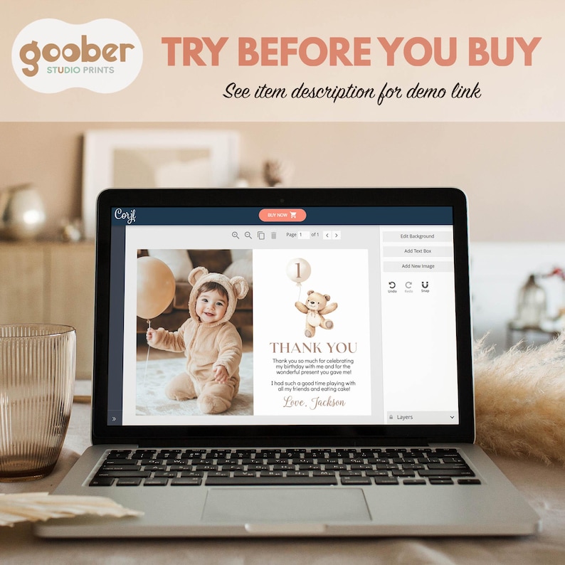 May include: A laptop screen displays a digital thank you card template featuring a photo of a baby in a bear-ear hood next to a graphic of a teddy bear holding a balloon with the number one. The text reads Thank You and Love, Jackson.