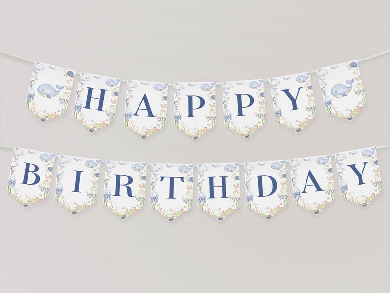 May include: A banner with the words "HAPPY BIRTHDAY" in navy blue letters. Each pennant has a watercolor design of a whale, jellyfish, and coral. The banner is strung on a white string, perfect for a birthday party.