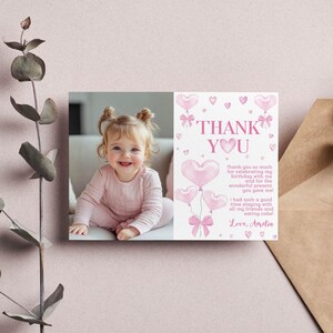 May include: Pink thank you card with a photo of a young girl and pink heart balloons. The text reads "Thank You" and "Thank you so much for celebrating my birthday with me and for the wonderful present you gave me! I had such a good time playing with all my friends and eating cake. Love, Amelia."