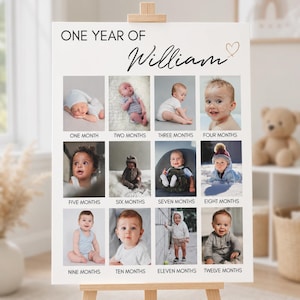 May include: A white milestone poster titled ONE YEAR OF William with a heart icon. It features twelve square photographs of a child arranged in a grid, each labelled with the corresponding month from one to twelve in black sans-serif text.