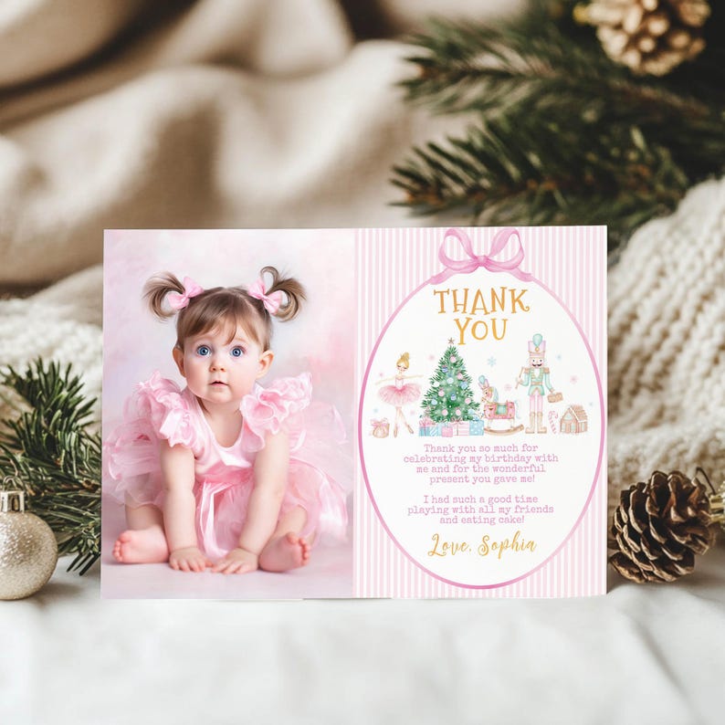 May include: A rectangular thank you card featuring a photograph of a toddler in a pink ruffled dress with hair bows on the left, and a pink striped background with a nutcracker, ballerina, and Christmas tree illustration on the right.