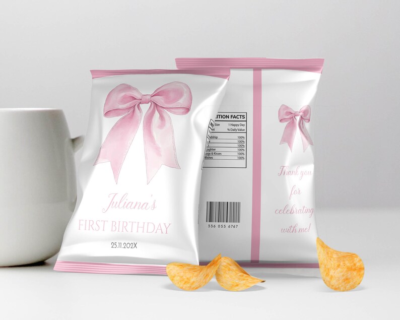 May include: Two white snack bags with pink trim featuring a large pink bow graphic. The front text reads Juliana's FIRST BIRTHDAY 25.11.202X. The back includes a nutrition facts label, a barcode, a smaller pink bow, and Thank you for celebrating with me!