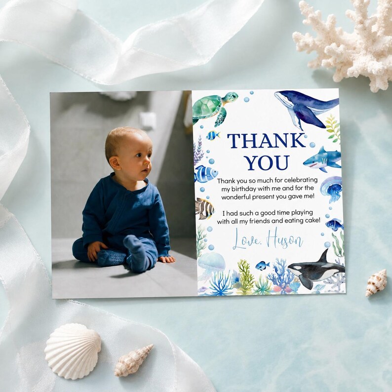 May include: A rectangular thank you card featuring a photograph of a child in a blue outfit on the left and an ocean-themed illustration on the right. The text reads THANK YOU, followed by a message of gratitude and the name Love, Huson.