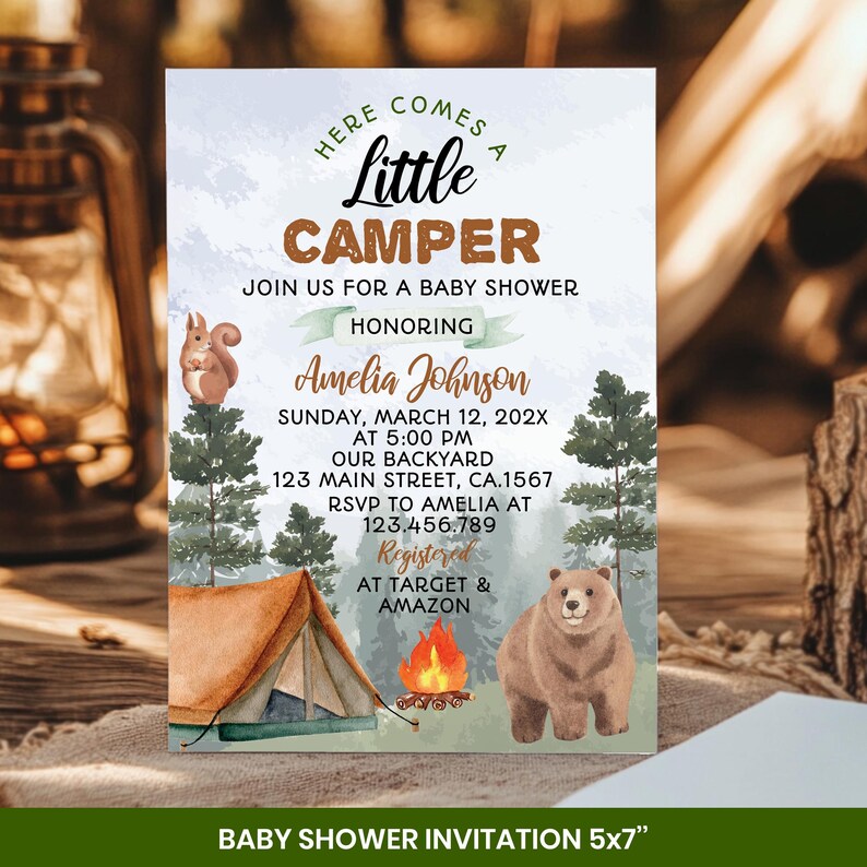 May include: A baby shower invitation with a camping theme. The design features a tent, campfire, bear, and squirrel illustrations. The invitation includes the text "Here Comes a Little Camper" and event details. The invitation measures 5x7 inches.