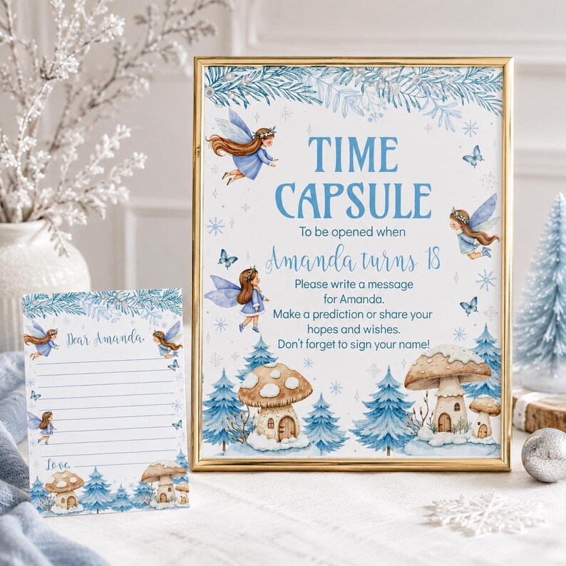May include: A gold-framed sign and matching card featuring blue fairy illustrations, snowy pine trees, and mushroom houses. The sign reads: TIME CAPSULE To be opened when Amanda turns 18. Please write a message for Amanda. Make a prediction or share your hopes and wishes. Don't forget to sign your name!