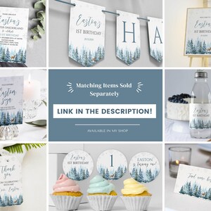 May include: A collection of winter-themed party stationery featuring a blue forest and deer illustration. Items include an invitation, banner, welcome sign, water bottle label, thank you tag, cupcake toppers, and a food tent card with snowflake accents.