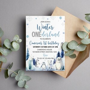 May include: A rectangular birthday invitation card featuring a white background with blue snowflakes, dark blue pine trees, and watercolor illustrations of a polar bear, two penguins, an arctic fox, and a seal, with text reading Winter ONEderland.