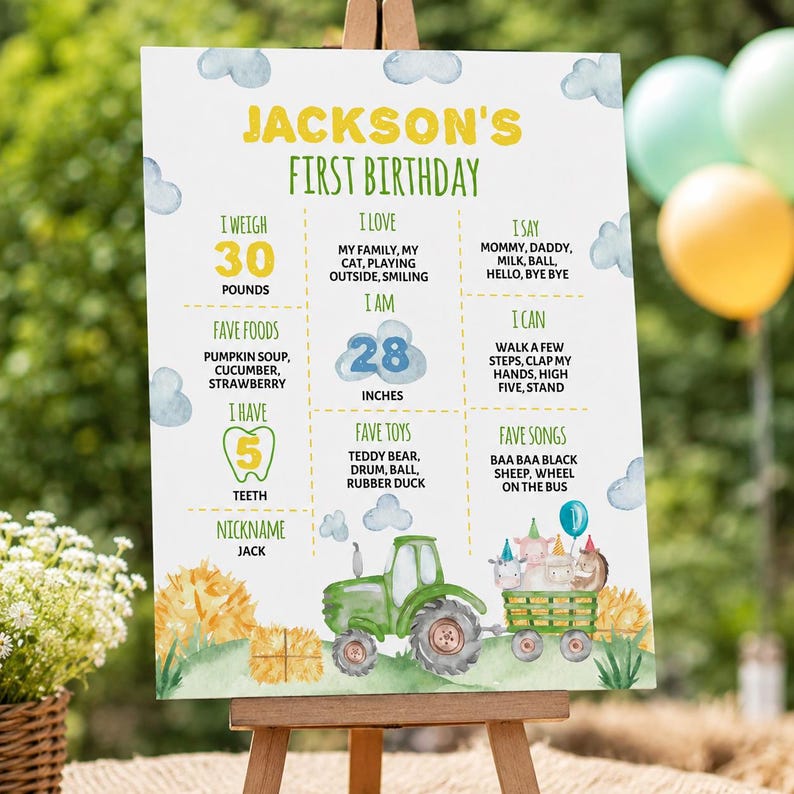 May include: A white first birthday milestone sign for Jackson featuring yellow and green text, blue clouds, and a green tractor pulling a trailer with cartoon animals. It lists weight as 30 pounds, height as 28 inches, and various personal facts.