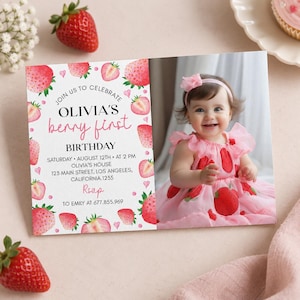 May include: A rectangular birthday invitation card featuring a watercolor strawberry border and a photograph of a smiling toddler wearing a pink strawberry-print dress and headband. The text reads: JOIN US TO CELEBRATE OLIVIA'S berry first BIRTHDAY.