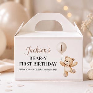 May include: A white cardboard gable box featuring a printed label with the text Jackson's BEAR-Y FIRST BIRTHDAY THANK YOU FOR CELEBRATING WITH ME! The design includes a brown teddy bear illustration holding a balloon with the number 1.