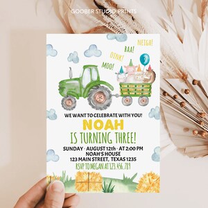 May include: A birthday invitation card featuring a green tractor pulling a wagon filled with farm animals wearing party hats. The text reads: WE WANT TO CELEBRATE WITH YOU! NOAH IS TURNING THREE! SUNDAY AUGUST 12th AT 2:00 PM NOAH'S HOUSE 123 MAIN STREET TEXAS 1235 RSVP TO MEGAN AT 123.456.789.