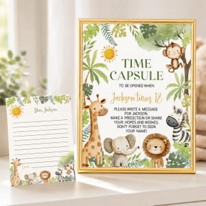 May include: A gold-framed sign and matching card featuring watercolour jungle animals including a giraffe, elephant, lion, monkey, and zebra. The sign reads: TIME CAPSULE TO BE OPENED WHEN Jackson turns 18. PLEASE WRITE A MESSAGE FOR JACKSON.